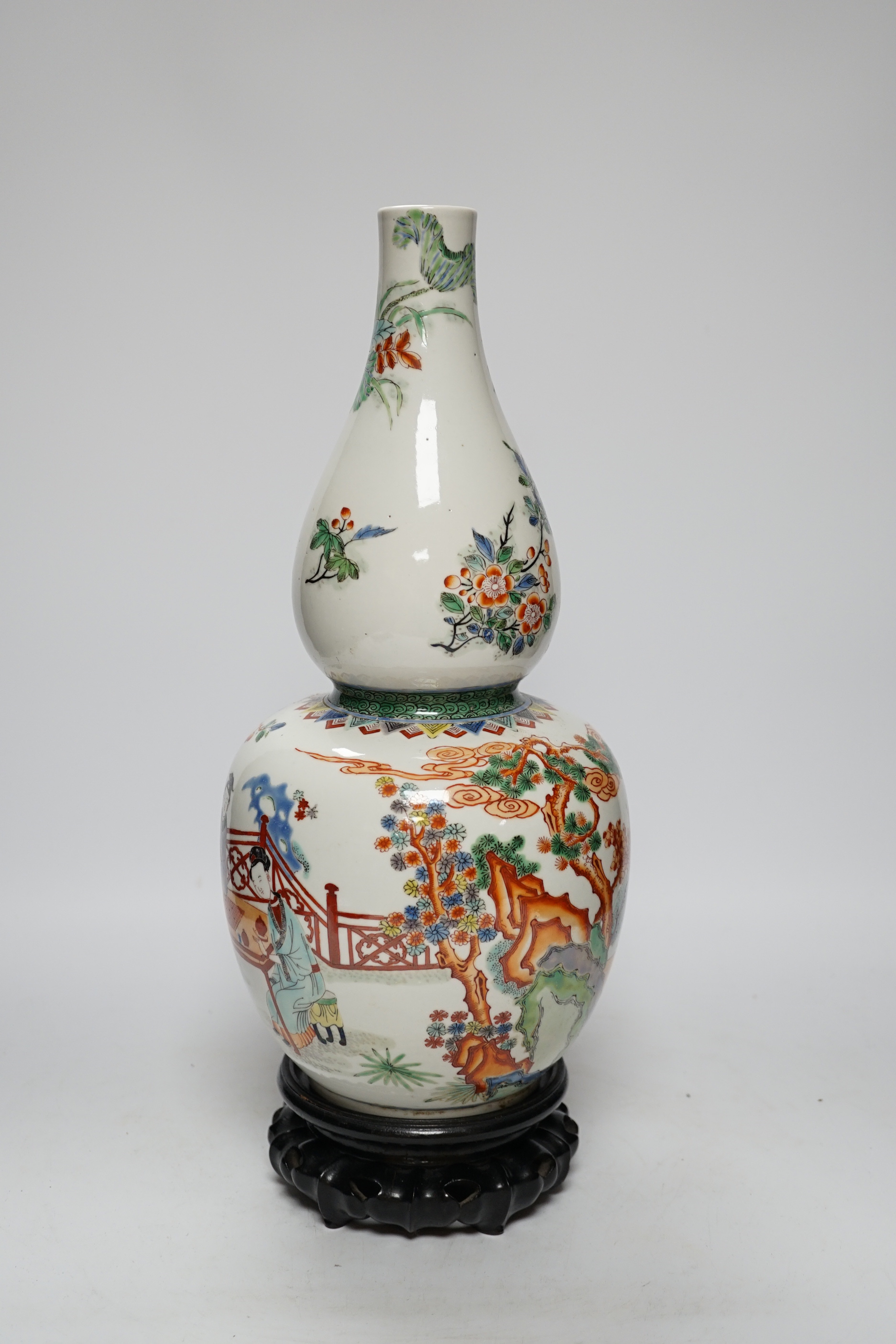 A Chinese enamelled porcelain double-gourd vase on hardwood stand, 41cm total height